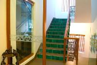 stair leading to the terrace has an emerald green handmade tile riser.